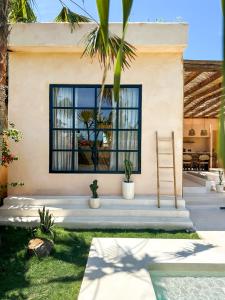 a house with a window and a ladder at Villa Mahuwa in Canggu