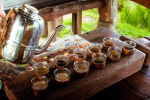 a tray of cups of coffee on a wooden table at Maha Gangga Valley by ecommerceloka in Tirtagangga
