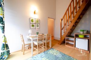 a kitchen and dining room with a table and chairs at Pokoje Grażyna in Jastarnia
