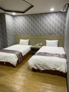 Postel nebo postele na pokoji v ubytování Mei Hua Hotel