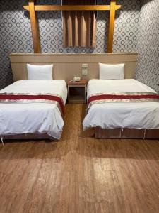 Postel nebo postele na pokoji v ubytování Mei Hua Hotel