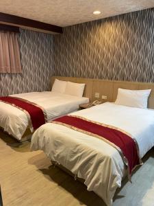 Postel nebo postele na pokoji v ubytování Mei Hua Hotel