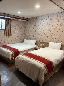 Postel nebo postele na pokoji v ubytování Mei Hua Hotel