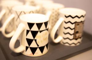 a group of coffee mugs sitting on a shelf at Casa Le Grey in Kuah