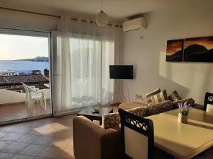 a living room with a couch and a table at Kela Apartments in Sarandë