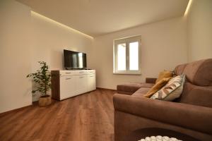 a living room with a couch and a television at SEDAMI in Maribor