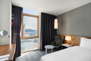 a hotel room with a bed and a window at Staz Hotel Ulsan in Ulsan