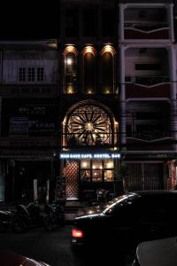 a building with a lit up facade at night at Man Cave Hostel Vientiane in Ban Nongdouang