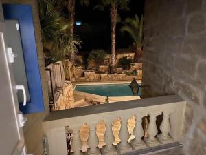 a view of a swimming pool through a window at Ta' Tereza in Xagħra