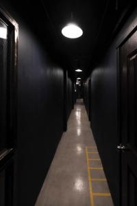 a dark hallway with a corridermottermottermott at Man Cave Hostel Vientiane in Ban Nongdouang