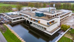 an aerial view of a building on the water at Fletcher Hotel-Restaurant Marknesse in Marknesse