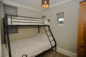 a bedroom with two bunk beds in a room at Lincoln Lodge, 2-bedroom,2-bathroom,ground floor flat in Southend-on-Sea