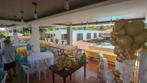 a room with a table and balloons and a pool at Bakawan Hideaway Resort and Restaurant in Tomas Oppus