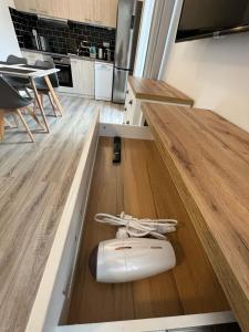 a white surfboard sitting on the floor of a kitchen at Apartment 123-2 Lipno Home in Lipno nad Vltavou