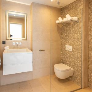 a bathroom with a toilet and a sink and a shower at Beau Clocher in Saint-Tropez