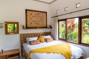 En eller flere senge i et værelse på Buddha Homestay