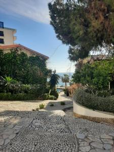 a cobblestone walkway in front of a house at Kela Apartment 3 in Sarandë