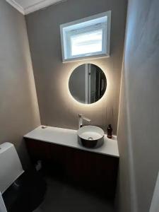 a bathroom with a sink and a mirror at Villa Vilu in Naantali