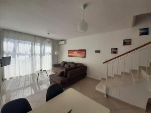 a living room with a couch and a table at Kela Apartment 3 in Sarandë