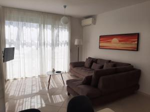 a living room with two couches and a television at Kela Apartment 3 in Sarandë +33 photos