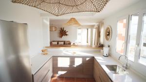 a bathroom with a sink and a large window at Villa Sunrise Fuerteventura by Smartclick in Corralejo