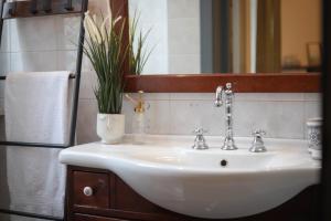 a white sink in a bathroom with a mirror at C'era Una Volta in Monopoli +42 photos