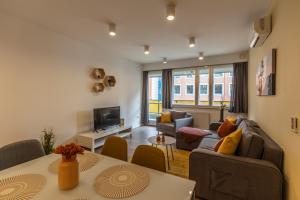 a living room with a couch and a table at Gems of Budapest - Tiger Eye Residence in Budapest