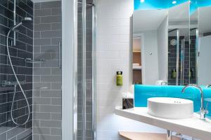 a bathroom with a sink and a shower at Holiday Inn Express Southwark by IHG in London