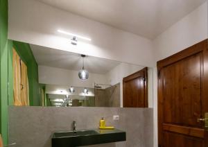 a bathroom with a sink and a mirror at Locanda del sorriso b&b in San Quirico dʼOrcia