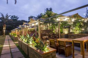 a restaurant with tables and chairs and lights at Hotel Boulevard Nairobi, City Centre CBD in Nairobi