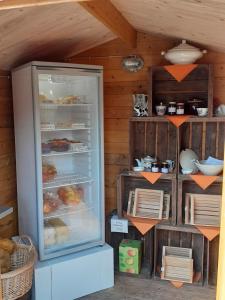 a refrigerator freezer sitting inside of a room at Ferienhof-Meyer in Wingst