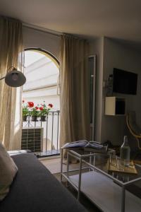 uma sala de estar com uma mesa e uma janela em Calle Abades Centro de Sevilla em Sevilha