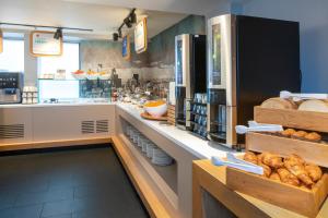 a bakery with a counter with bread on it at Holiday Inn Express Southwark, an IHG Hotel in London