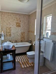 a bathroom with a tub and a toilet and a sink at Exclusive Private Room in Joburg No loadshedding in Johannesburg