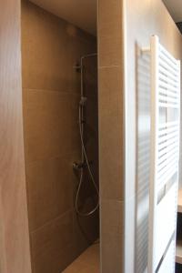 a bathroom with a shower stall with a shower at De Landweg in Tielt