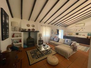 a living room with a couch and a table at Casa das Oliveiras in Avis