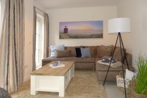 a living room with a couch and a table at Aurelia Haus 1 in Wyk auf Föhr