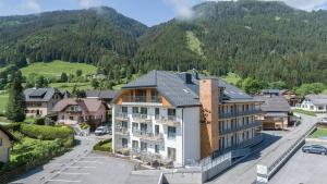 un bâtiment dans une ville avec des montagnes en arrière-plan dans l'établissement Apartment Ski&Nature "Grosseck", à Mauterndorf 5 autres photos