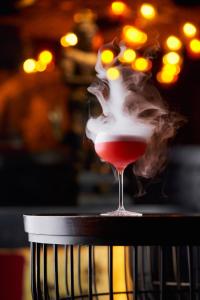 a drink in a wine glass sitting on a table at Grand Millennium Business Bay in Dubai