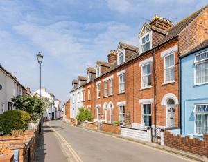 a row of brick houses on a street at Family & pet Friendly, Stylish & Spacious Beach House in Gorleston-on-Sea