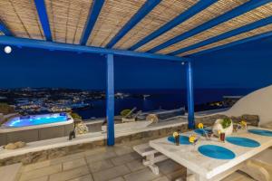 a bathroom with two sinks and a swimming pool at Mykonos Psarou Place in Psarou