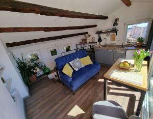 a living room with a blue couch and a table at Casa 39 Apartments in Rovinj
