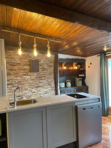 a kitchen with a sink and a counter top at LE WÜRM in Monnet-la-Ville