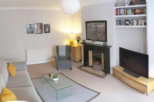 a living room with a couch and a fireplace at Townhouse Apartment Carlisle in Carlisle