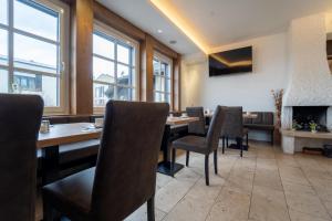 a dining room with a table and chairs and a fireplace at Hotel St Georg - Regensburg in Regensburg