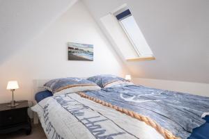 Schlafzimmer mit einem Bett und einem Fenster in der Unterkunft Haus Strandwinkel Ferienwohnung "Strandwinkel 1" in Scharbeutz