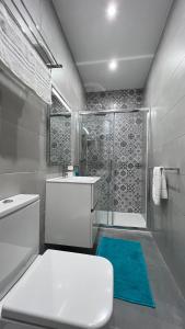 a bathroom with a white toilet and a shower at Flat in Valletta in Valletta
