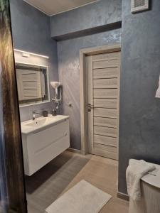 a bathroom with a white sink and a mirror at Alecsa 2 Luxury Residence in Mamaia +23 photos