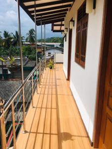 a balcony of a house with a wooden floor at SILVER RAIL in Galle