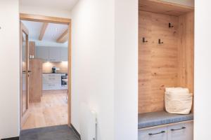 a kitchen with a wood paneled wall and a counter at Apartment Eden Großbichl 